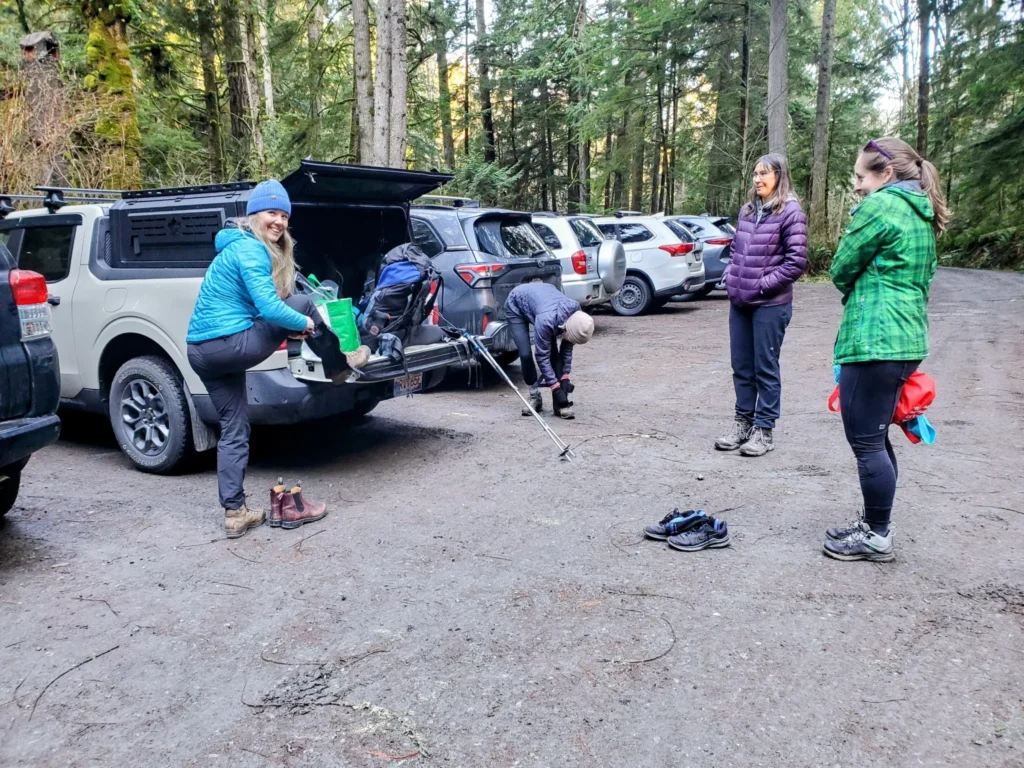 hikers gathering at a parking lot to begin a hike